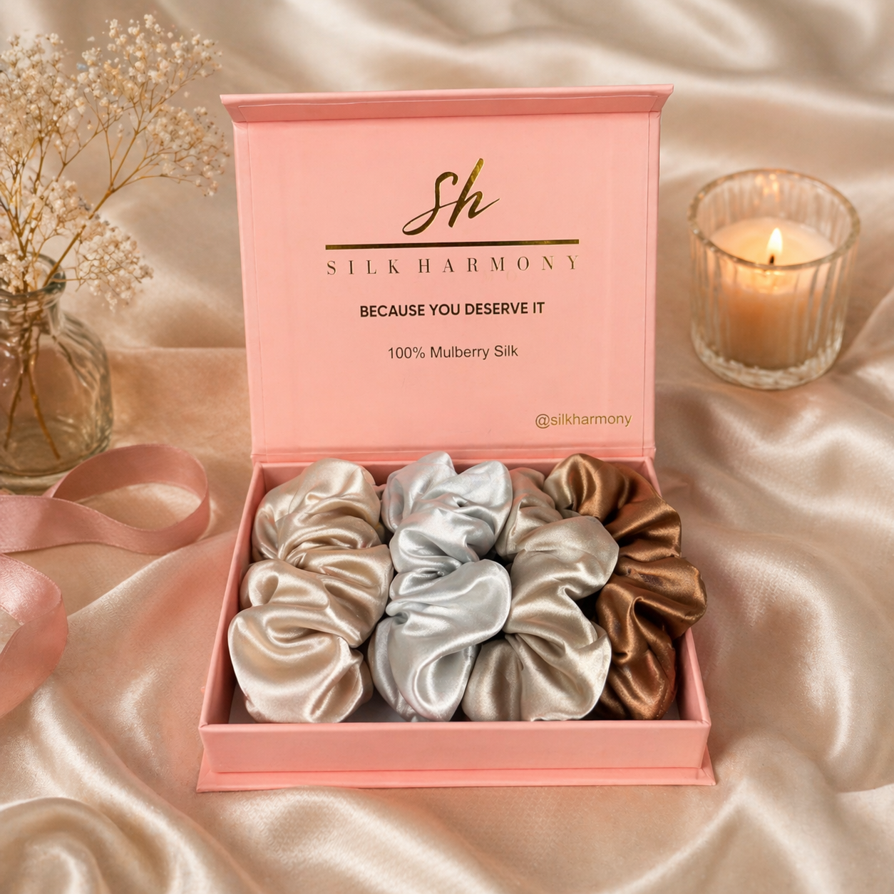 Silk scrunchies in a pink box with 'Silk Harmony' branding on a satin surface.